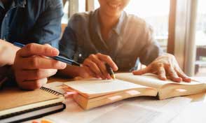 Two colleagues discussing at a desk