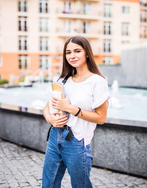 Two women happily studying English together on a laptop.