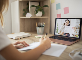 A woman in a medical uniform smiling in a group.