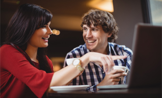 A woman in a medical uniform smiling in a group.