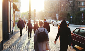 Traveller with suitcase at airport window, representing new journeys and global opportunities with Berlitz.